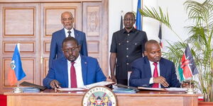 President William Ruto (far right), and Haiti Prime Minister Ariel Henry (far left) witnessed the signing of the agreement on the deployment of 1,000 police officers to Haiti.