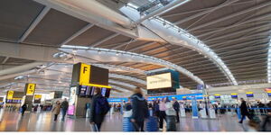 Travellers at a terminal within the Heathrow Airport in London 