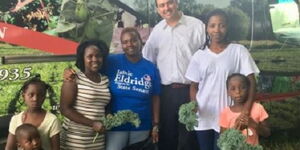 Henrietta Isaboke (Middle) and her family with a representative of World Farmers Program.