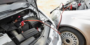A car using a jumper starter to start