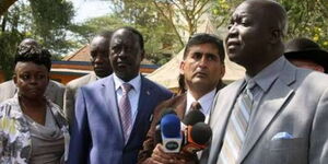 A photo of former Gem MP Jakoyo Midiwo (right) with Raila Odinga with other ODM leaders at a past event.