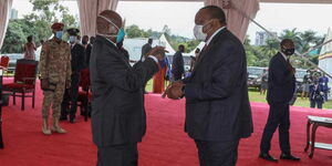 President Uhuru Kenyatta (right) during the inauguration of President Yoweri Kaguta Museveni in Kampala, Uganda on Wednesday, May 12.