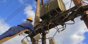 A photo of a Kenya Power technician working on power lines