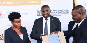 Immigration PS Julius Bitok (center) and other officials receive passport booklets in Nairobi