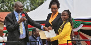 Immigration and Citizen Services Principal Secretary (PS) Julius Bitok (left) issuing certificates in Meru County on Friday May 5, 2023