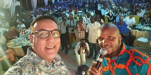Tourism CS Najib Balala (left) takes a selfie with Media personality Jalang'o during the Chambers of commerce end year party and awards on December 6, 2019.
