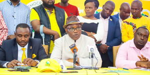 Former Kisii Governor James Ongwae (centre) addresses the media at the United Democratic Alliance (UDA) centre in Nairobi on March 29, 2023. UDA Secretary-General Cleophas Malala (left) was also in attendance. 