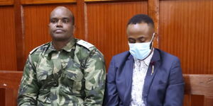 Joseph Irungu alias Jowie (right) follows proceedings at Milimani Law Courts on March 13, 2024.