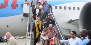 An undated file image of tourists alighting from a plane