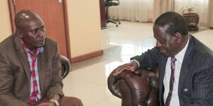 Former Kiambu Governor William Kabogo (left) speaking with ODM leader Raila Odinga.