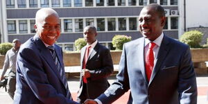 Former Transport CS Michael Kamau (left) greets President William Ruto (right)