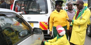 City Hall parking attendants clamping a vehicle at the Nairobi CBD. 