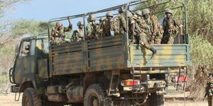 Kenyan troops disembark from a military vehicle at the Kenya-Somalia border in October 2011. 