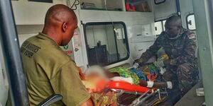 KDF officers assisting a woman with her newborn baby in Congo in August 2023