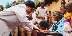 Kericho Woman Rep Beatrice Kemei Chebaibai attending to Mama Rachel Chepkwony at her home in Kuresiet,  Seretut Cheptororiet ward on January 16, 2023