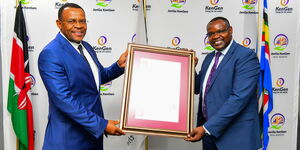 KenGen MD and CEO Peter Njenga, ( left) receives ISO 450012018 certificate from Bureau Veritas Representative (right).