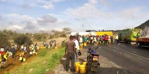 Residents of Athi River in Machakos scrambling for crude oil after trailer overturns at Lukenya area on March 27, 2024