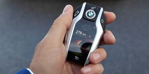 A man holding a keyless car fob.