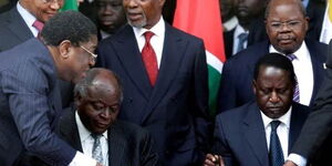 Late Former President Mwai Kibaki(left) and the late Former Prime Minister Raila Odinga signing a power-sharing agreement deal in 2008.