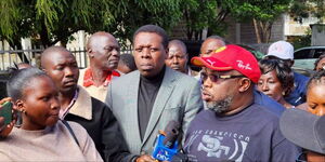 The family member of Enoch Kibunguchy addressing the press alongside the DAP-Kenya party leader on Tuesday, December 23, 2025.