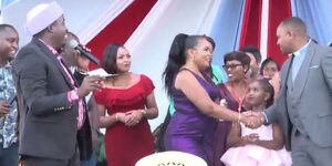 Kameme radio presenter Muthee Kiengei (right) addresses the crowd alongside his former wife, Keziah wa Kairuki and their daughter, Orpah Waithera on Sunday, May 29 at Ruiru stadium. 