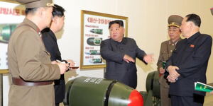 North Korean leader Kim Jong Un (C) inspects what state media reported were tactical nuclear warheads 