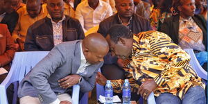 Interior CS Kithure Kindiki (left) chats with one of the leaders during a church service at Chaaria Catholic Church on Sunday May 7, 2023. 