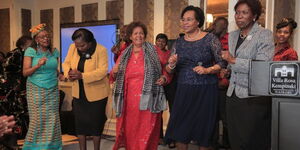 Former Cabinet Secretary Margaret Kobia with women leaders dance to a tune at Villa Rosa Kempinski on Wednesday, November 30, 2022.