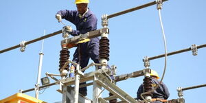 Kenya Power technician fixing lines on a pole on February 15, 2023