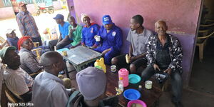kuria shares a cup of tea with mbeere residents