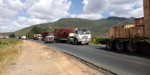 A convoy of trucks with abnormal loads on the road