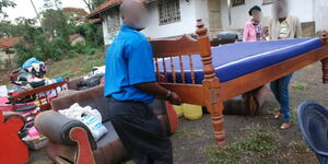 Nakuru residents take part of their belongings following an eviction in 2019.