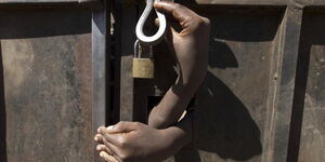 File image of someone opening a locked gate