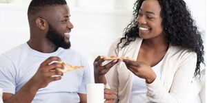 A file image of a man and woman sharing a meal.