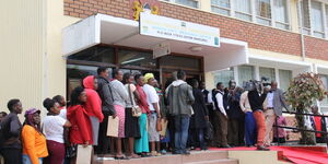 Kenyans queueing at a government office in Nakuru Town in 2019.