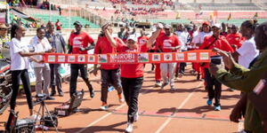 First Lady Margaret Kenyatta celebrates as she crosses the line in the 5 km category of the Nairobi City Marathon event. 
