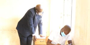 CS Magoha viewing an empty desk at St Paul's Agenga School in Migori on March 26, 2021.