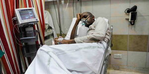 Boniface Mwangi in hospital after he sustained injuries during a protest.