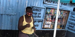 Mama Mboga in Kibera settlement wearing a face mask to protect against covid-19 virus.