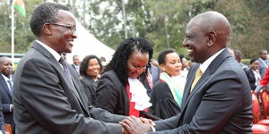 President William Ruto exchanges pleasantries with ex-Chief Justice David Maragaduring the swearing-in of judges at State House Nairobi on Wednesday, September 14, 2022.