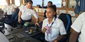 Marine Pilot Elizabeth Marami on a ship alongside other crew members