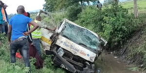 Residents helping to cart the wreckage of a matatu after an accident in Embu on Saturday April 15, 2023