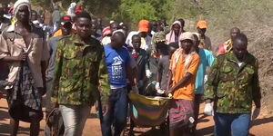 Residents of Adele in Madogo carry the body of the deceased