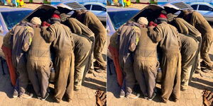 A group of mechanics repairing a car.
