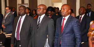 Interior Cabinet Secretary Kithure Kindiki ( in red tie) alongside Interior Principal Secretary Raymond Omollo ( middle) during a meeting 