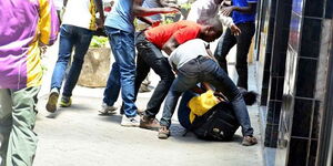 A gang assaulting a female pedestrian in Nairobi.
