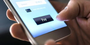 An image of a person conducting a mobile money transfer
