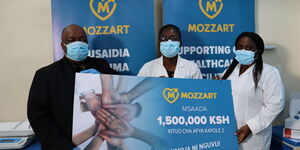 Mozzart Bet team presents a dummy cheque representing the donation to Kayole 2 Sub county Hospital