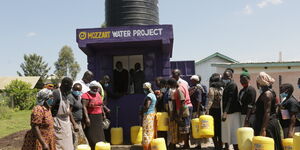 Residents of Imbo village in Homa Bay County enjoy free water provided by Mozzart Bet