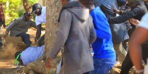 Homa Bay Town MP Peter Kaluma falls to the ground as a mob attacks him and his bodyguard at Agoro Sare Primary School, November 27, 2025.